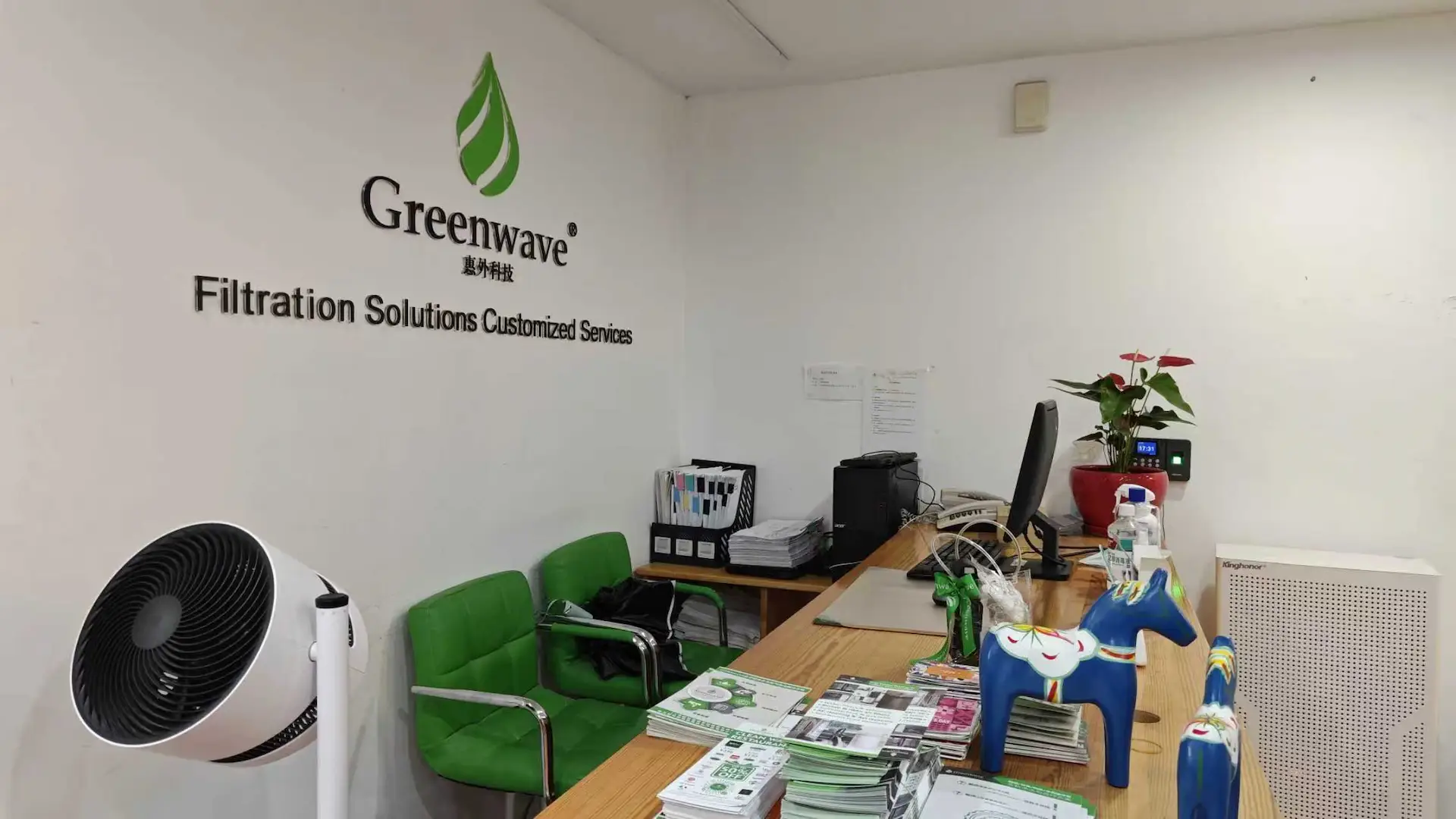 Greenwave logo wall with seating at the Shanghai visitor center.