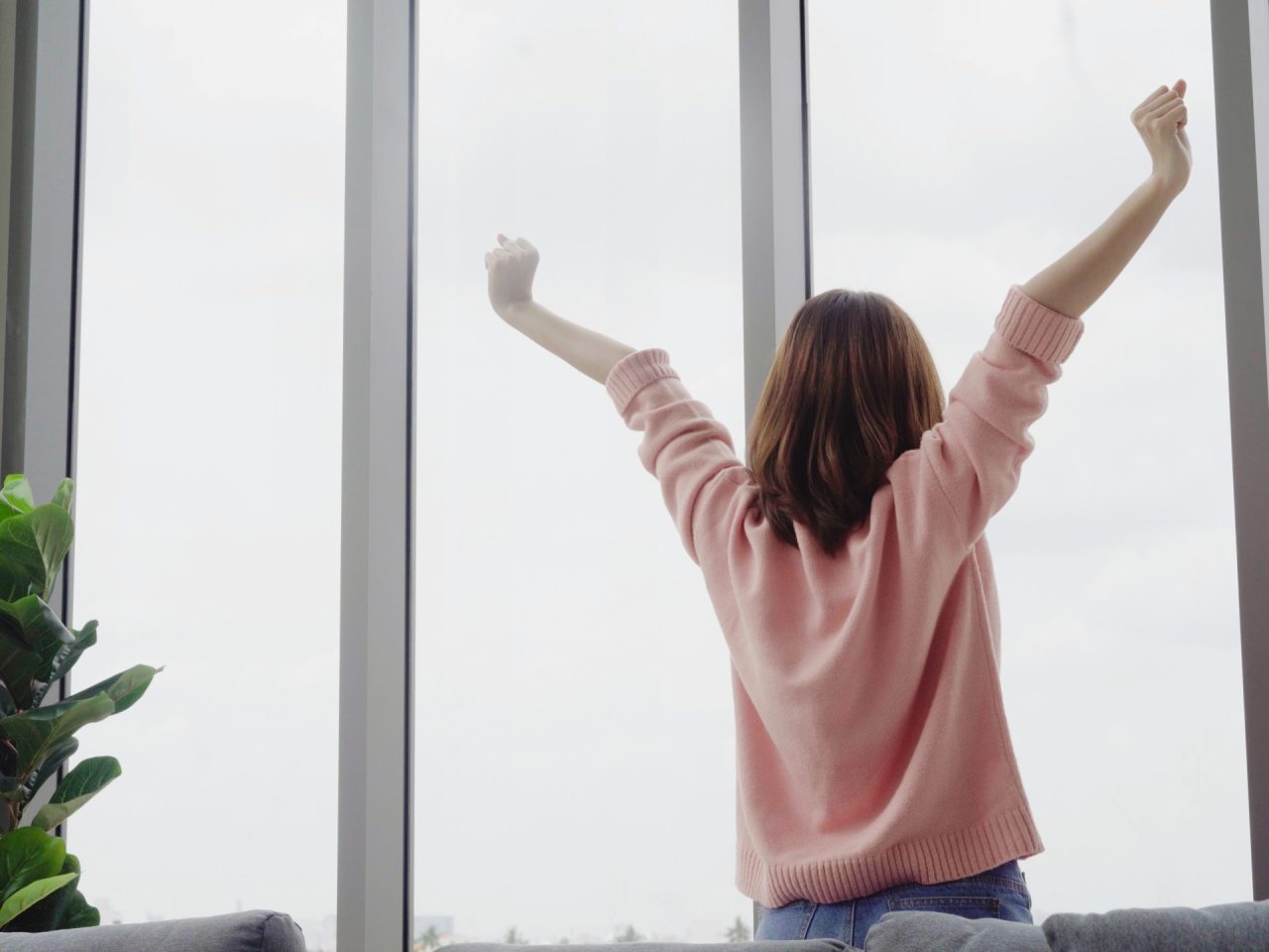 Portrait of beautiful Asian woman stretching her body and her ar Portrait of beautiful Asian woman stretching her body and her arms after she wake up feel sleepy in her bedroom at home. Lifestyle woman at home concept.